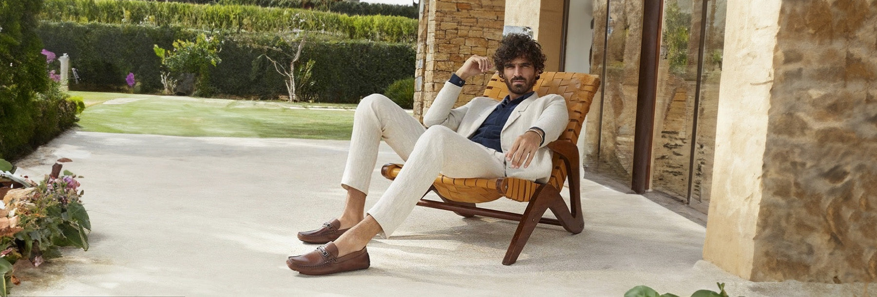 man sitting on a chair wearing democrata loafers
