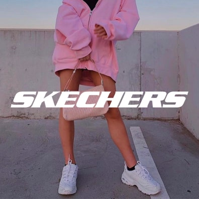 Girl wearing white skechers shoes with logo