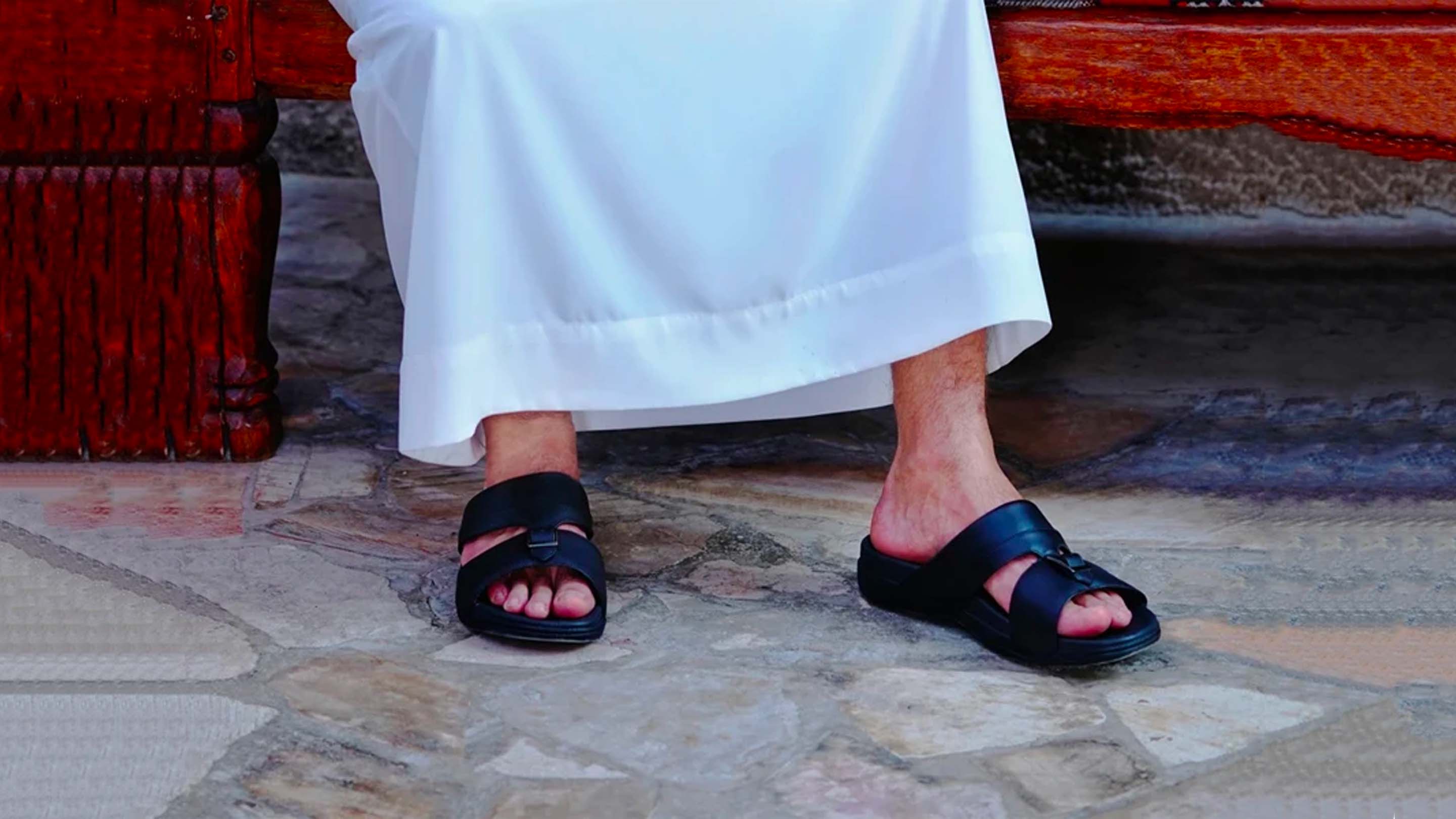 man wearing arabic sandals